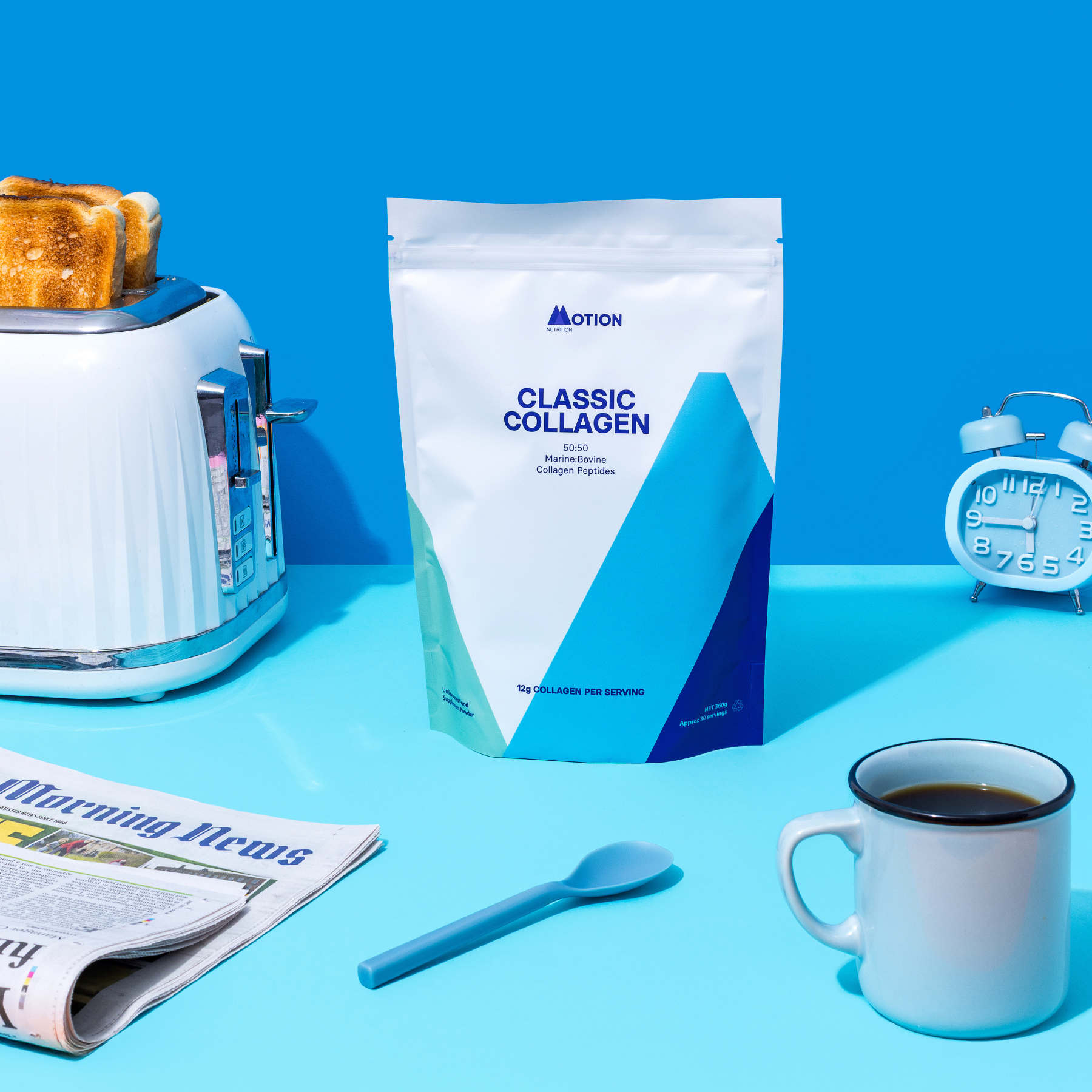 Collagen powder package with a cup of coffee, toaster, and newspaper on a blue background