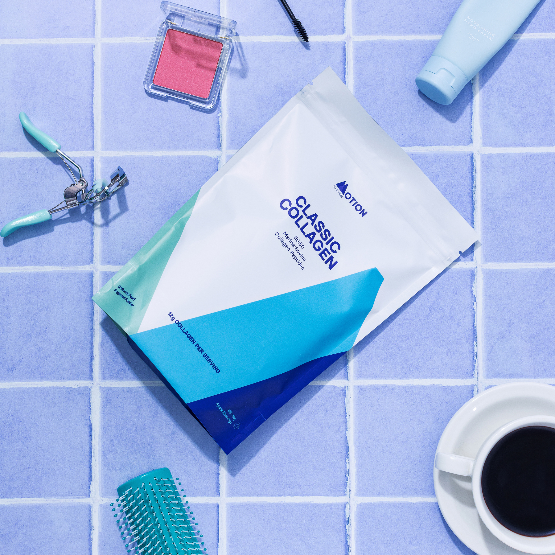 Cosmetic items including a mask, blush, and eyelash curler on a blue grid background.